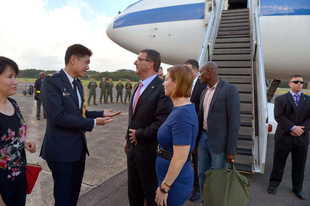 U.S. Defense Secretary Ash Carter and his wife, Stephanie, talk with Brig. Gen. Leong Kum Wah, Singapore's defense attache, upon their arrival at Paya Lebar Air Base in Singapore, May 28, 2015.