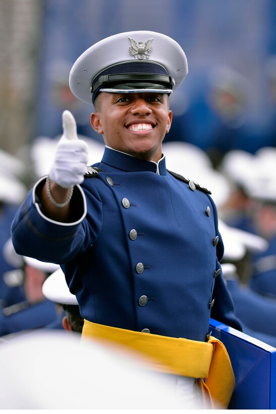 Cadet Kaz Moffett gives a thumbs-up after receiving his diploma from ...