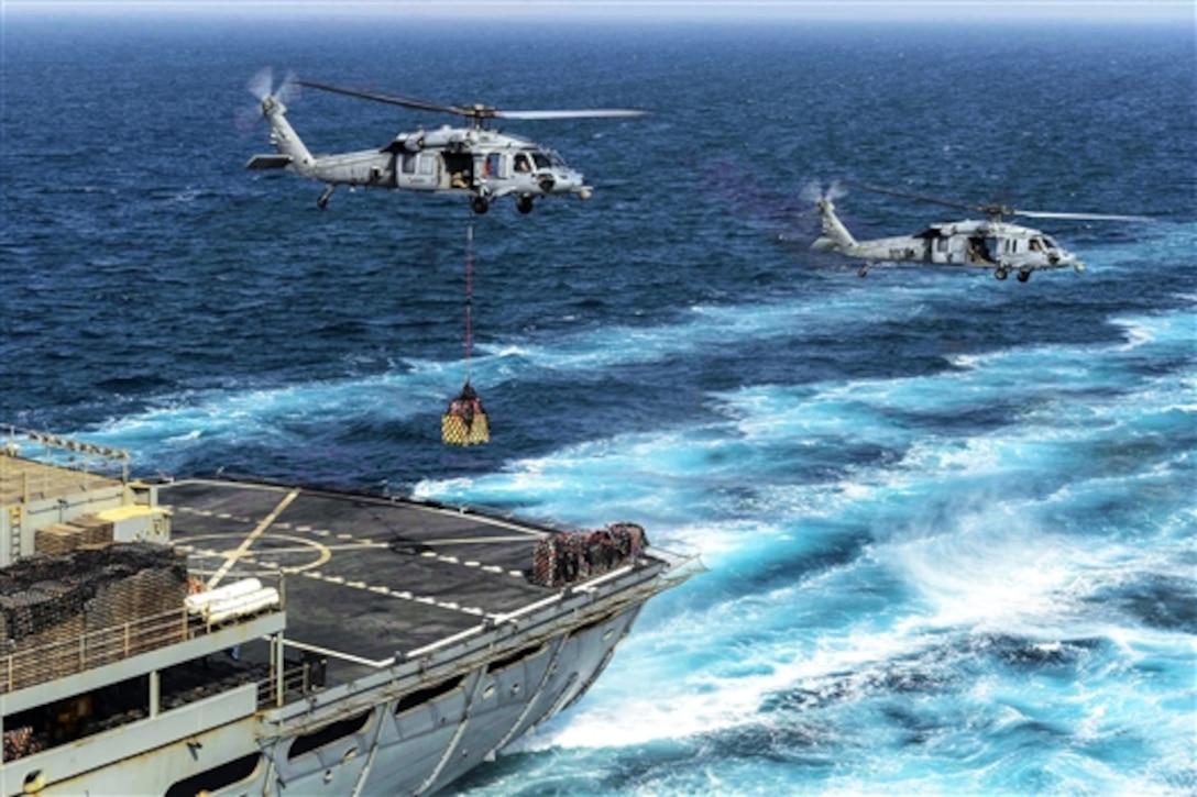 An MH-60S Seahawk helicopter picks up supplies from the Military Sealift Command Fast Combat Support Ship USNS Arctic during a replenishment with the aircraft carrier USS Theodore Roosevelt in the 5th Fleet area of operations, May 20, 2015. The Roosevelt is supporting Operation Inherent Resolve, which includes strike operations in Iraq and Syria as directed. The Seahawk is assigned to Helicopter Sea Combat Squadron 22. 