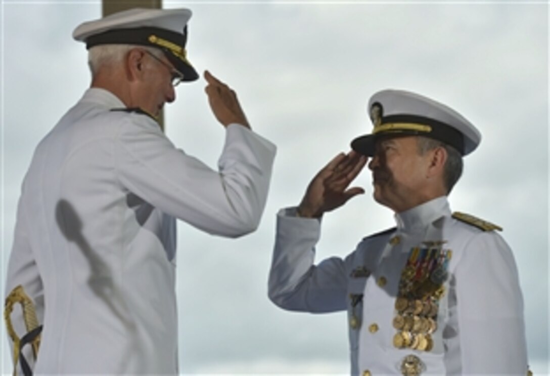 Outgoing U.S. Pacific Command Commander Navy Adm. Samuel J. Locklear, III, left, salutes Navy Adm. Harry B. Harris Jr., the incoming Pacom commander, during the change-of-command ceremonies for U.S. Pacific Command and U.S. Pacific Fleet in Honolulu, May 27, 2015. 