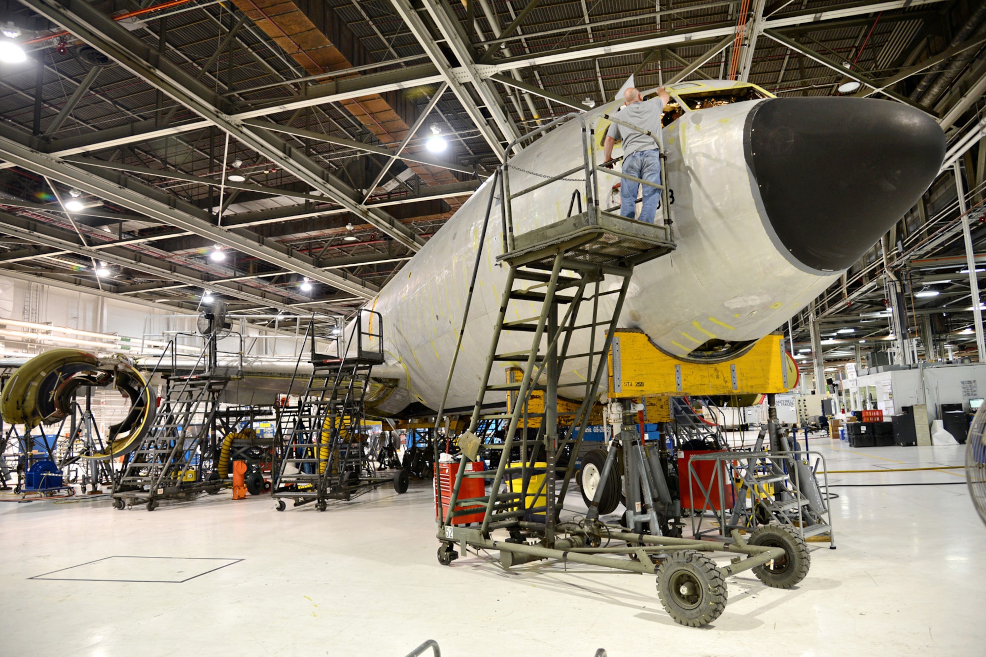 Aircraft Mechanic Steven Harris, 564th Aircraft Maintenance Squadron, preps the #1 and #4 window areas for installation on a KC-135 Stratotanker. The workers in programmed depot maintenance line recently broke their own record by completing a PDM in 86 days. (Air Force photo by Kelly White/Released)