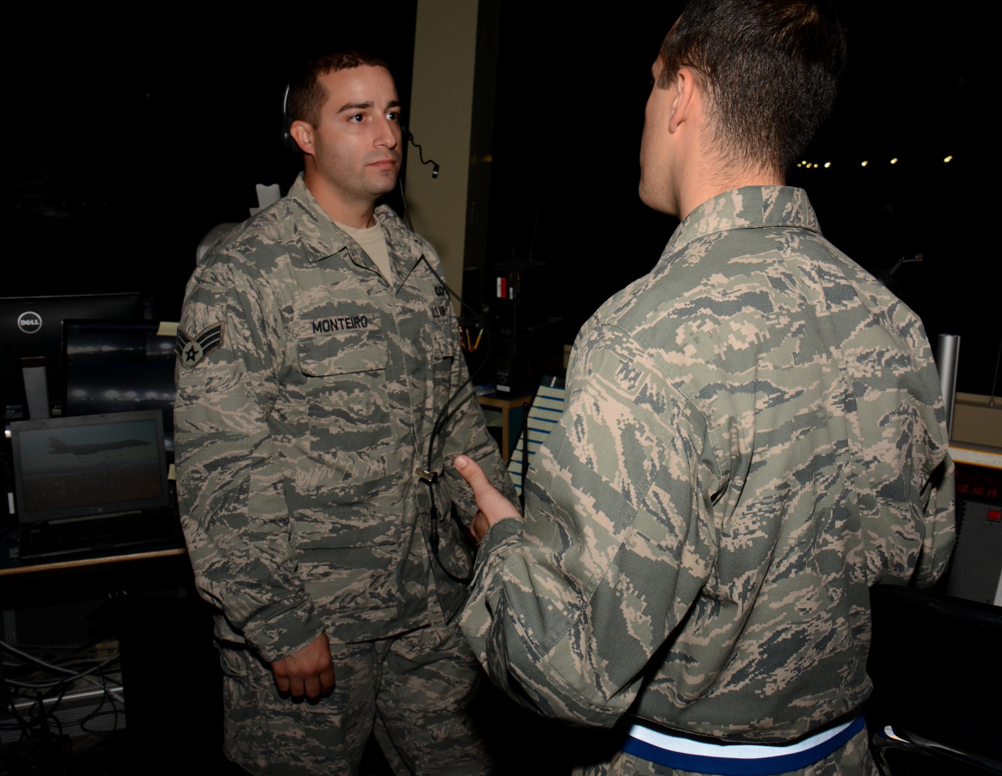 Senior Airman Kenneth Monteiro (Left), 379th Operations Support Squadron air traffic controller, meets with 379th Air Expeditionary Wing Chaplain (Capt.) Christopher De Luise (Right), inside the tower at Al Udeid Air Base, Qatar Oct. 31 during a chaplain led Blitz Program visit. The program focuses on visiting shift workers and informing those airmen of the resources available to them. More than 20 professionals took part in the Halloween visit with 379th Expeditionary Operations Group airmen. (U.S. Air Force photo by Tech. Sgt. James Hodgman)