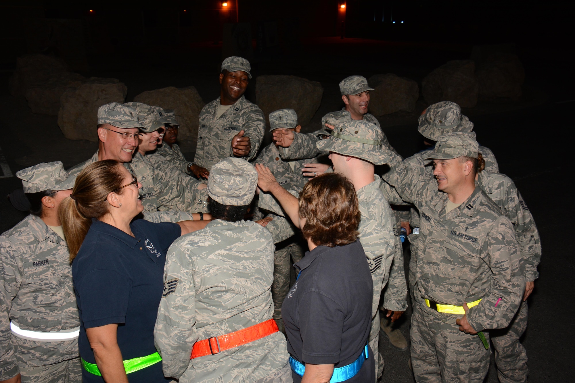 Service members and professionals from a variety of specialties come together for a group cheer at Al Udeid Air Base, Qatar Oct. 31 after conducting the chaplain led Blitz Program. The program focuses on visiting shift workers and informing those airmen of the resources available to them. More than 20 professionals took part in the Halloween visit with 379th Expeditionary Operations Group airmen. (U.S. Air Force photo by Tech. Sgt. James Hodgman) 