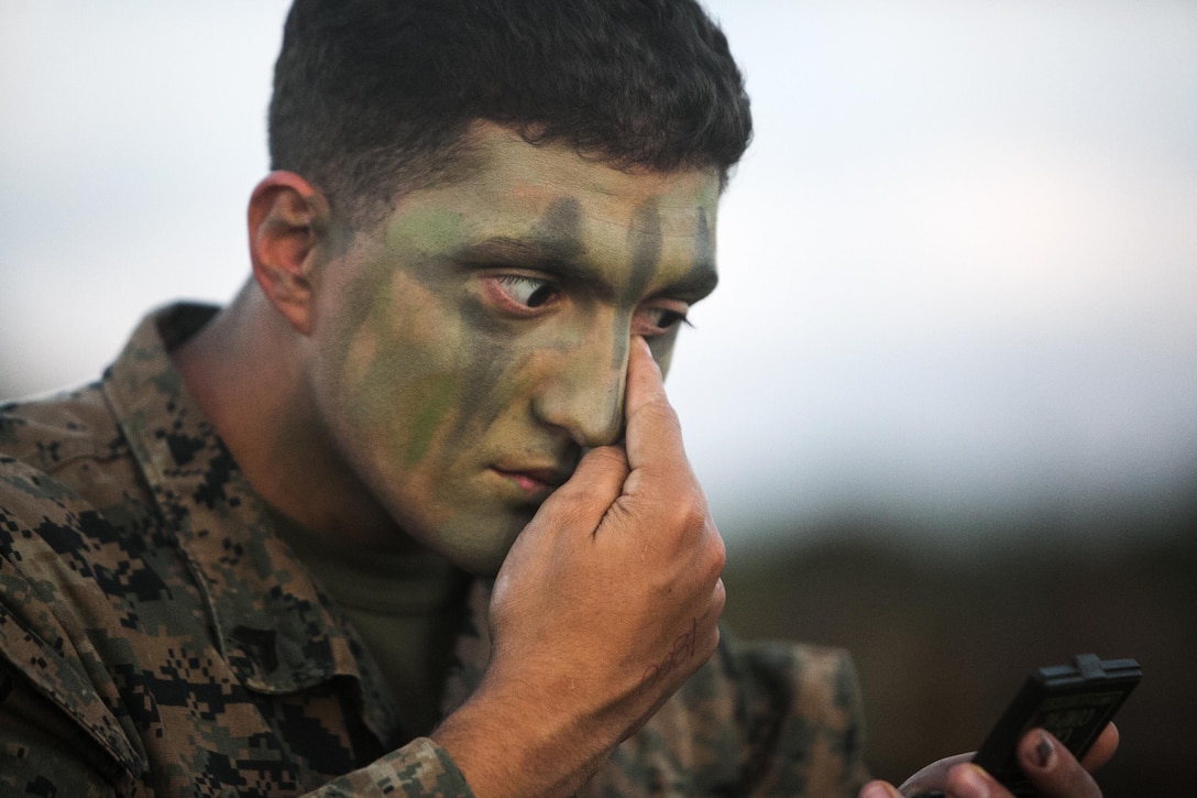 Cpl. Michael B. Wheeler, from Buffalo, New York, applies camouflage paint on Camp Hansen, Okinawa, Japan, while preparing for a regimental air assault during Blue Chromite 2016, Oct. 31, 2015.
Blue Chromite is a large-scale amphibious exercise that draws primarily from III Marine Expeditionary Force’s training resources on Okinawa. The location of the training allows participating units to maintain a forward-deployed posture and eliminates the cost of traveling to train. Wheeler is a machine gunner with 1st Battalion, 2nd Marine Regiment, 2nd Marine Division, II MEF, currently under the command of 4th Marines, 3rd MarDiv, III MEF. (U.S. Marine Corps photo by Cpl. Drew Tech/Released)