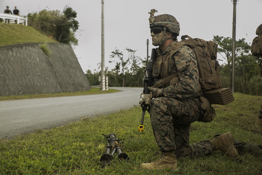 Cpl. Michael B. Wheeler, from Buffalo, New York, kneels during a patrol halt in the Jungle Warfare Training Area, Okinawa, Japan, after landing for a regimental air assault during Blue Chromite 2016, Oct. 31, 2015. The Okinawa jungle provided realistic training for Blue Chromite, a large-scale amphibious exercise that draws primarily from III Marine Expeditionary Force’s training resources on Okinawa. The location of the training allows participating units to maintain a forward-deployed posture and eliminates the cost of traveling to train. Wheeler is a machine gunner with 1st Battalion, 2nd Marine Regiment, 2nd Marine Division, II MEF, currently under the command of 4th Marines, 3rd MarDiv, III MEF. (U.S. Marine Corps photo by Cpl. Drew Tech/Released)