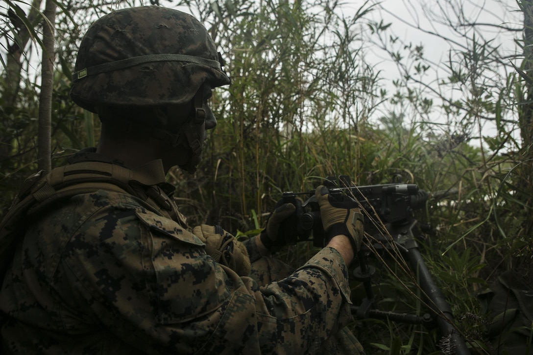 Lance Cpl. Adam Gentilin, from Troy, Pennsylvania, stands security on a M2 .50-caliber Browning machine gun in the Jungle Warfare Training Area, Okinawa, Japan, as part of a regimental air assault during Blue Chromite 2016, Oct. 31, 2015. Blue Chromite is a large-scale amphibious exercise that draws primarily from III Marine Expeditionary Force’s training resources on Okinawa. The location of the training allows participating units to maintain a forward-deployed posture and eliminates the cost of traveling to train. Gentilin is a machine gunner with 1st Battalion, 2nd Marine Regiment, 2nd Marine Division, II MEF, currently under the command of 4th Marines, 3rd MarDiv, III MEF. (U.S. Marine Corps photo by Cpl. Drew Tech/Released)