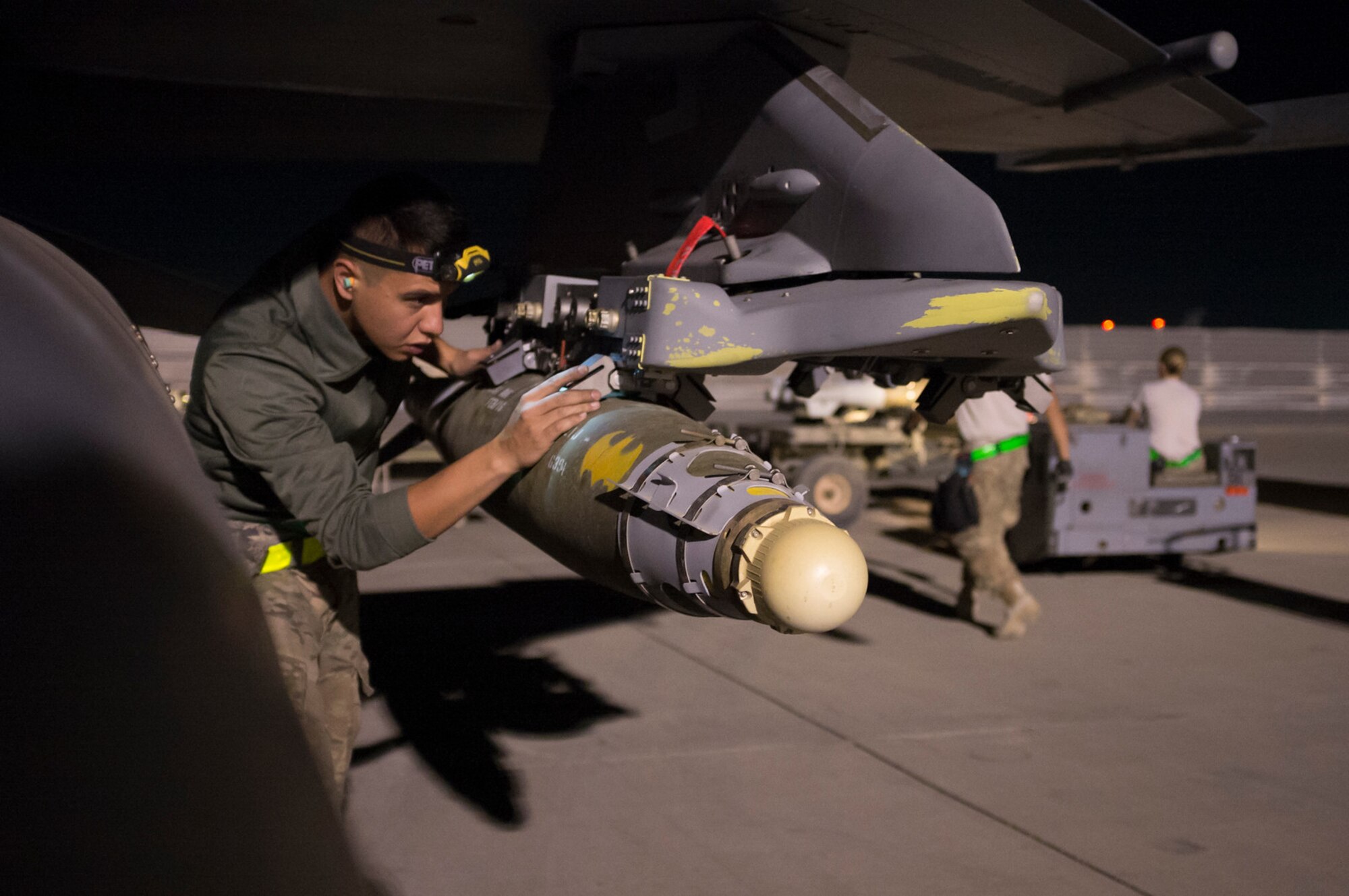 Airman 1st Class David Ojeda, 455th Expeditionary Aircraft Maintenance Squadron weapons load crew member, inspects the Bomb Release Unit after the Guided Bomb Unit-38 is loaded onto an F-16 Fighting Falcon at Bagram Airfield, Afghanistan, Sept. 23, 2015. The F-16 is a multi-role fighter aircraft that is highly maneuverable and has proven itself in air-to-air and air-to-ground combat.  (U.S. Air Force photo by Master Sgt. Kevin Crawford/Released)