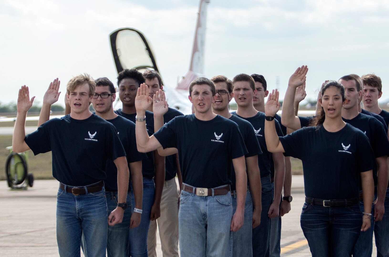 Air Force recruits recite the oath of enlistment at Joint Base San Antonio-Randolph Oct. 31, 2015. The enlistment was held before the U.S. Thunderbirds performance at the 2015 JBSA Air Show & Open House at JBSA-Randolph. In attendance were friends and family who witnessed the enlistment.(U.S. Air Force photo by photo by Johnny Saldivar)
