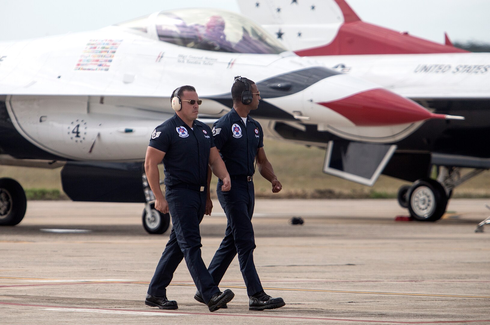 U.S. Air Force Air Demonstration Squadron "Thunderbirds" team members walk in formation after launching their aircraft during the Joint Base San Antonio Air Show and Open House Oct. 31, 2015 at Joint Base San Antonio-Randolph, Texas. Air shows allow the Air Force to display the capabilities of our aircraft to the American taxpayer through aerial demonstrations and static displays and allowing attendees to get up close and personal to see some of the equipment and aircraft used by the U.S. military today. (U.S. Air Force photo by photo by Johnny Saldivar)