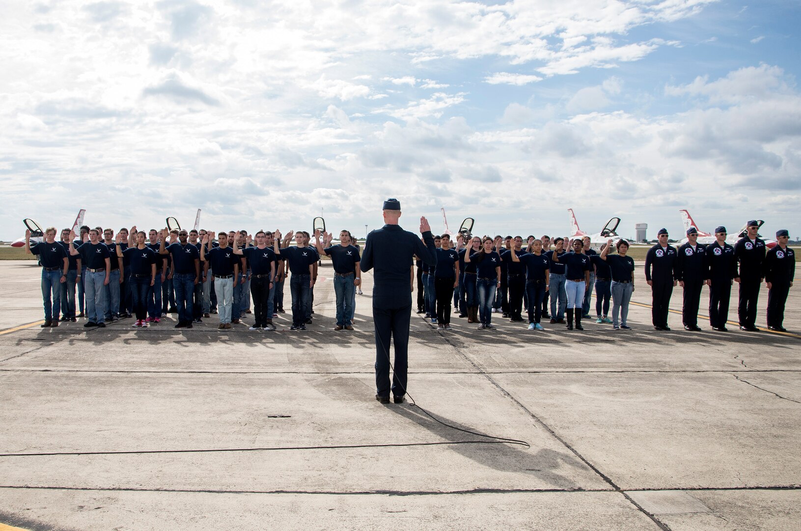 Lt. Col. Christopher Hammond, commander/leader of the U.S. Air Force Air Demonstration Squadron, administered the oath of enlistment to new Air Force recruits at Joint Base San Antonio-Randolph Oct. 31, 2015. The enlistment was before the U.S. Thunderbirds performance at the 2015 JBSA Air Show & Open House at JBSA-Randolph. In attendance were friends and family who witnessed the enlistment.(U.S. Air Force photo by photo by Johnny Saldivar)