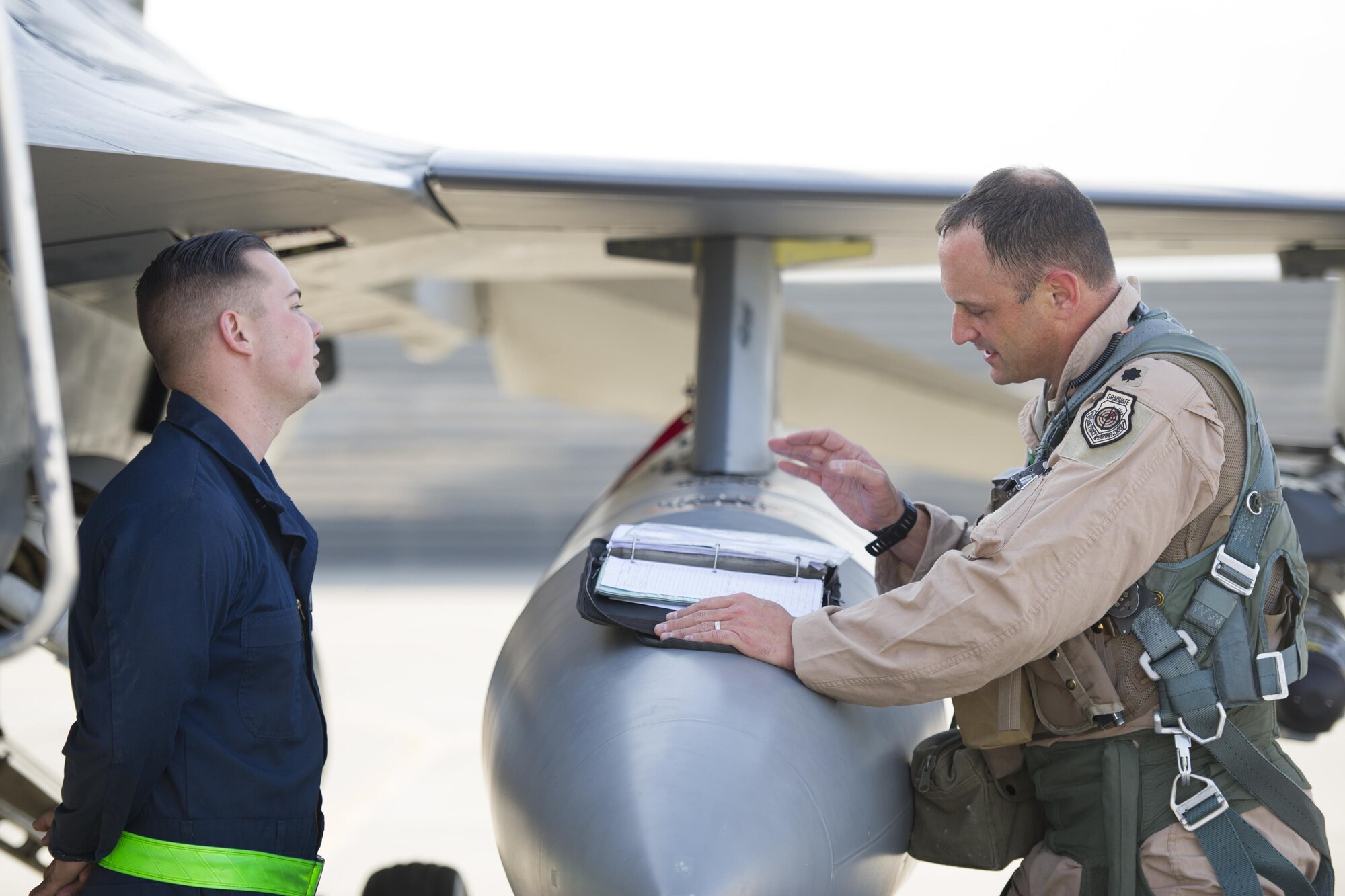 Senior Airman Zachary Szalay, 455th Expeditionary Aircraft Maintenance Squadron crew chief, deployed from Aviano Air Base, Italy, speaks with Lt. Col. Michael Meyer prior to a sortie at Bagram Airfield, Afghanistan, Oct. 30, 2015. The 421st Fighter Squadron, known as the “Black Widows,” from Hill Air Force Base, Utah, arrived here Oct. 28, 2015 in support of Operation Freedom’s Sentinel and NATO’s Resolute Support mission. (U.S. Air Force photo/Tech. Sgt. Robert Cloys/RELEASED)