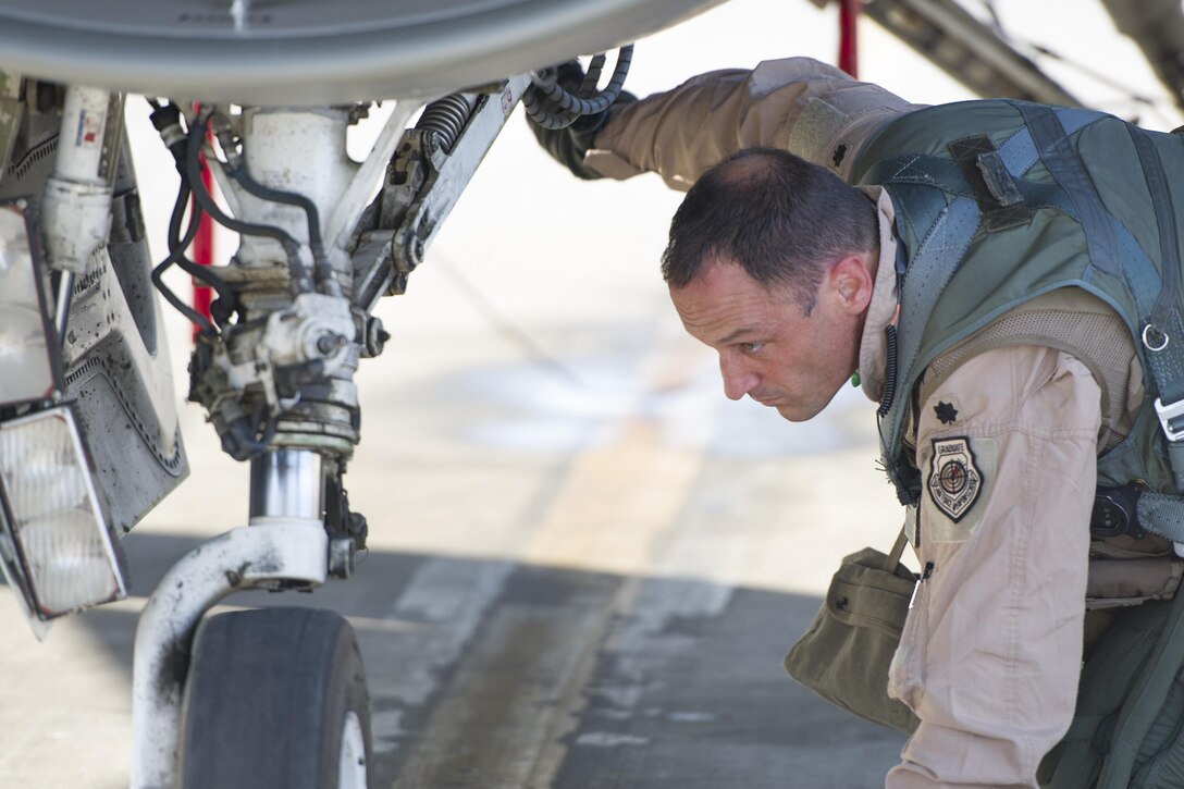 Lt. Col. Michael Meyer, 421st Expeditionary Fighter Squadron commander, deployed from Hill Air Force Base, Utah, performs pre-flight checks on an F-16 Fighting Falcon at Bagram Airfield, Afghanistan, Oct. 30, 2015. Airmen assigned to the 421st FS, known as the “Black Widows,” arrived here Oct. 28, 2015 in support of Operation Freedom’s Sentinel and NATO’s Resolute Support mission. (U.S. Air Force photo/Tech. Sgt. Robert Cloys/RELEASED)