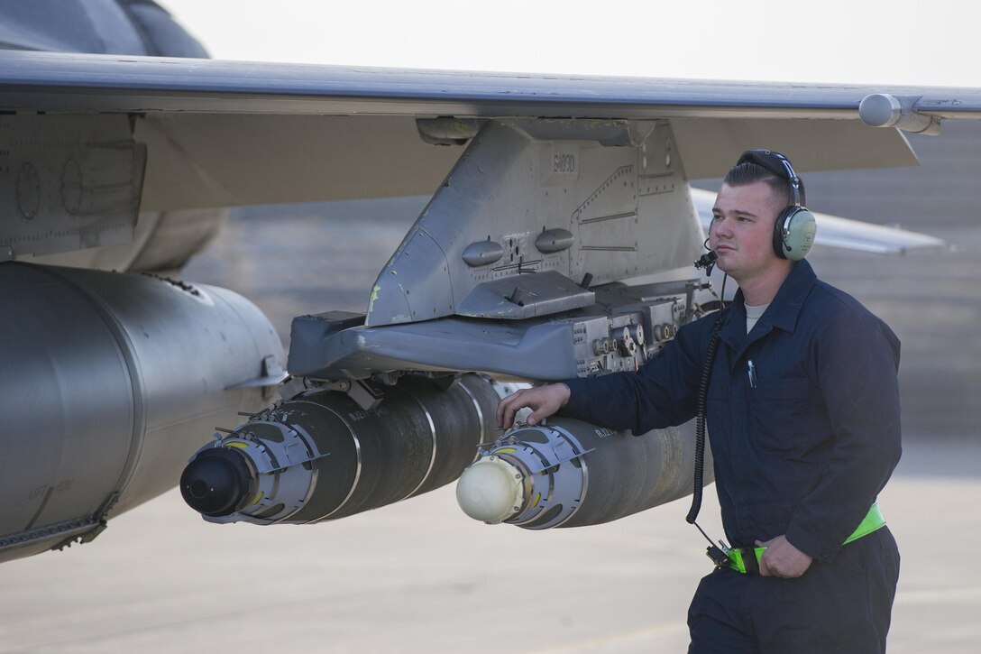 Airman 1st Class Zachary Szalay, 455th Expeditionary Aircraft Maintenance Squadron crew chief, deployed from Aviano Air Base, Italy, performs a preflight inspection on an F-16 Fighting Falcon piloted by Lt. Col. Michael Meyer, 421st Expeditionary Fighter Squadron commander, deployed from Hill Air Force Base, Utah, at Bagram Airfield, Afghanistan, Oct. 30, 2015. The 555th EFS, deployed from Aviano Air Base, Italy, is nearing the end of it's six-month deployment at Bagram and will hand the reigns over to the 421st EFS in support of Operation Freedom's Sentinel and NATO's Resolute Support mission. (U.S. Air Force photo/Tech. Sgt. Robert Cloys/RELEASED)