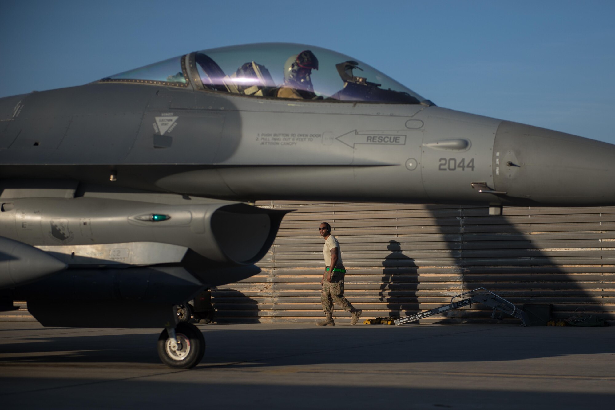 Capt. Tyler McBride, 421st Expeditionary Fighter Squadron chief of safety, deployed from Hill Air Force Base, Utah, prepares for his first combat sortie as Staff Sgt. Devon Sheffey, 455th Expeditionary Aircraft Maintenance Squadron crew chief, deployed from Aviano Air Base, Italy, looks on after removing the chocks from the F-16 Fighting Falcon at Bagram Airfield, Afghanistan, Oct. 30, 2015. The 555th EFS, deployed from Aviano Air Base, Italy, is nearing the end of its six-month deployment at Bagram and will hand the reins over to the 421st EFS in support of Operation Freedom's Sentinel and NATO's Resolute Support mission. (U.S. Air Force photo by Tech. Sgt. Joseph Swafford/Released)