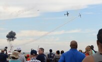 A crowd of visitors to Joint Base San Antonio-Randolph watches the Tora Tora Tora react the Dec. 7, 1941, attack on Pearl Harbor the 2015 JBSA Air Show and Open House Oct. 31. Air shows allow the Air Force to display the capabilities of our aircraft to the American taxpayer through aerial demonstrations and static displays and allowing attendees to get up close and personal to see some of the equipment and aircraft used by the U.S. military today. (U.S. Air Force photo by Senior Airman Krystal Wright)