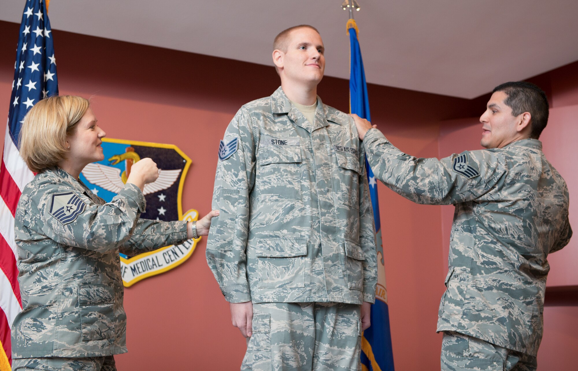 Master Sgt. Tanya Hubbard and Staff Sgt. Roberto Davila, both assigned to the 60th Medical Group, tack staff sergeant stripes onto Spencer Stone, a 60th Medical Operations Squadron medical technician, during a promotion ceremony at Travis Air Force Base, Calif., Oct. 30, 2015. Stone was promoted to the rank of staff sergeant, effective Nov. 1, by order of Air Force Chief of Staff Gen. Mark A. Welsh III. Stone was promoted to staff sergeant for the leadership and courage he showed in August when he and two friends thwarted a potential terrorist attack on a train traveling to Paris. (U.S. Air Force photo/Ken Wright)