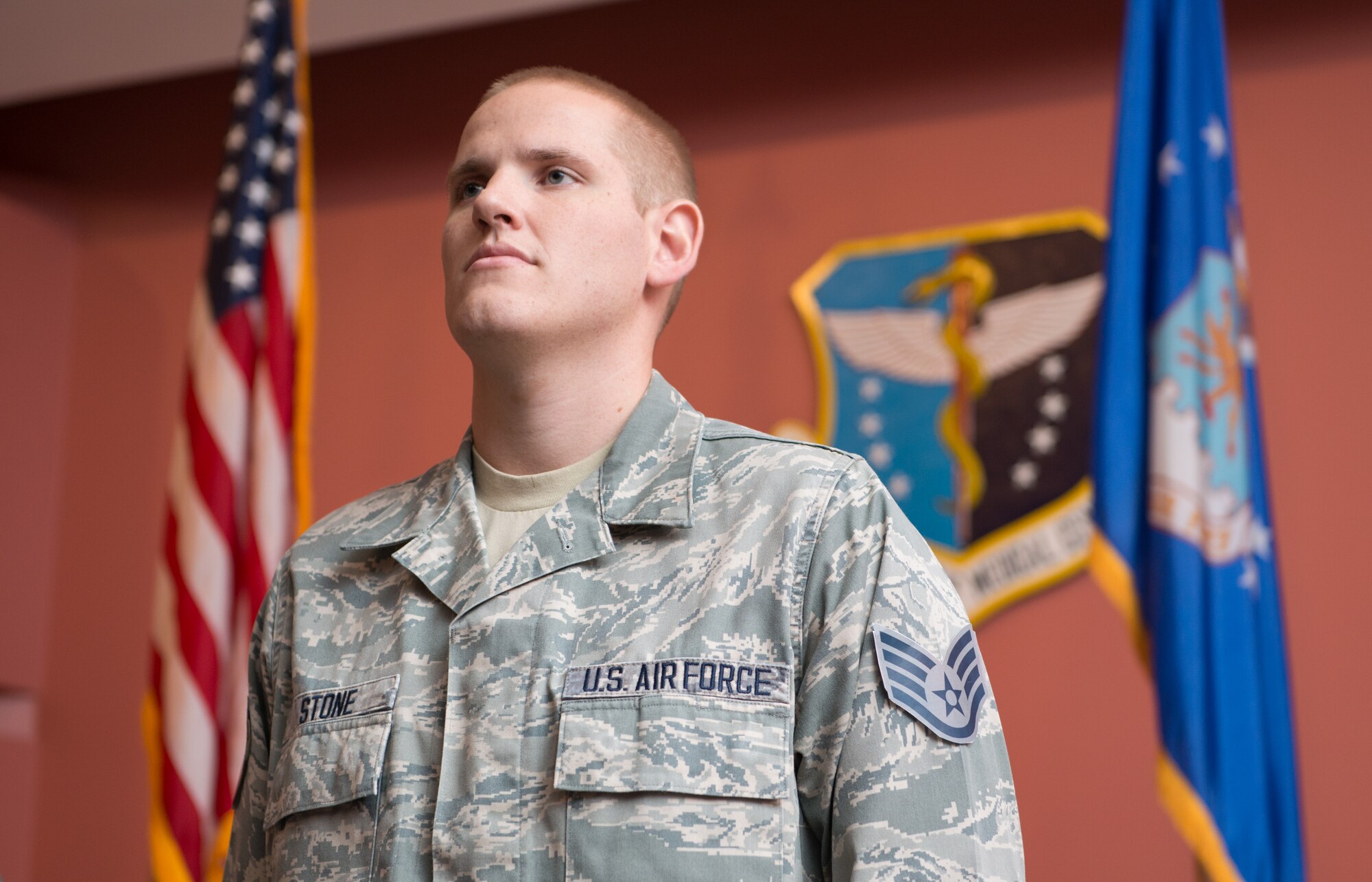 Staff Sgt. Spencer Stone, a 60th Medical Operations Squadron medical technician, listens as the responsibilities of noncommissioned offers are read during a promotion ceremony at Travis Air Force Base, Calif., Oct. 30, 2015. Stone was promoted to the rank of staff sergeant effective, Nov. 1, by order of Air Force Chief of Staff Gen. Mark A. Welsh III. Stone was promoted to staff sergeant for the leadership and courage he showed in August when he and two friends thwarted a potential terrorist attack on a train traveling to Paris. (U.S. Air Force photo/Ken Wright)