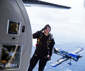 Staff Sergeant Roman Grijalva, U.S. Army Golden Knights demonstration team parachutist, salutes as he jumps into the air during their routine Oct. 31 at the 2015 Joint Base San Antonio Air Show and Open House at JBSA-Randolph. Air shows allow the Air Force and sister services to display the capabilities of military aircraft and members to the American taxpayer through aerial demonstrations and static displays.