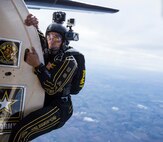 Staff Sgt. Jonathon Lopez, U.S. Army Golden Knights demonstration team tandem jump cameraman, prepares to jump with a fellow parachutist and tandem jumper exiting the aircraft during the team’s routine Oct. 31 during the 2015 Joint Base San Antonio Air Show and Open House at JBSA-Randolph. The Golden Knights have a threefold mission: recruit the next generation of Soldiers, support public outreach through conducting tandem parachute jumps and compete against the world’s best skydivers at national and international parachuting competitions.