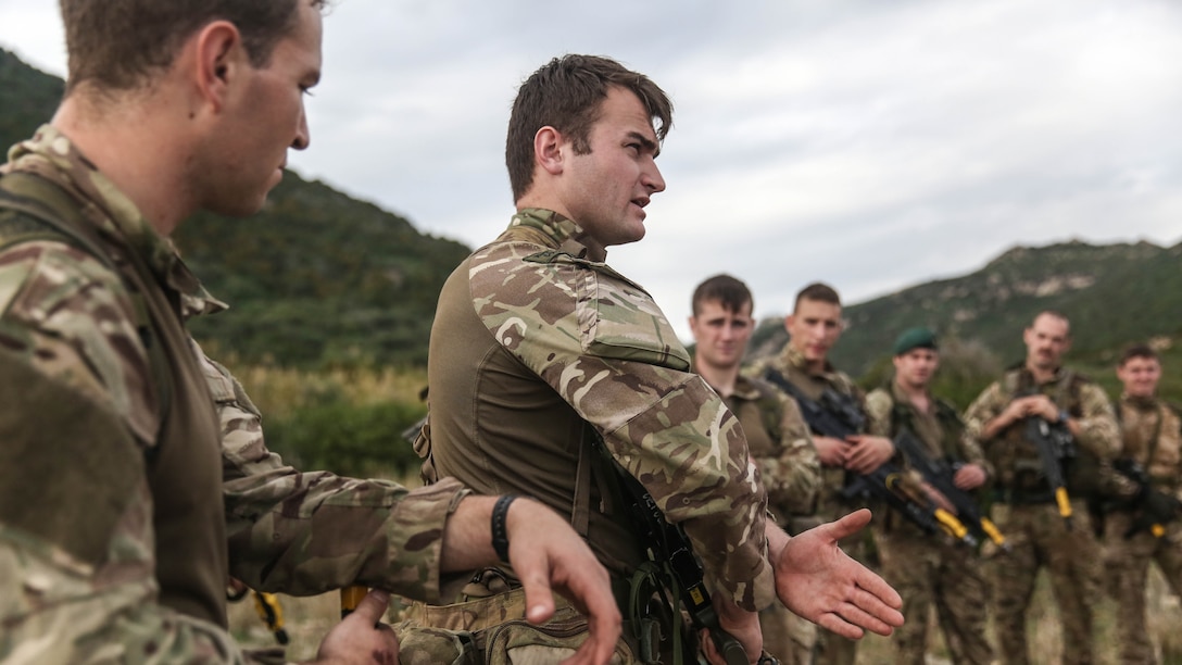 Royal Marines with 45 Commando and U.S. Marines with Special-Purpose Marine Air-Ground Task Force Crisis Response-Africa discuss tactics and techniques for patrols during Trident Juncture 15, Oct. 21, 2015. Trident Juncture is one of many exercises ensuring that NATO is ready to deal with any emerging crisis from any direction, and that the Alliance is able to work effectively with partner nations. 