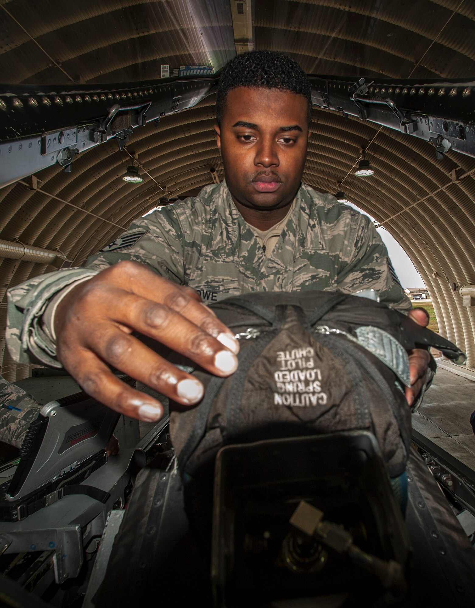 Staff Sgt. Angelo Lowe, 8th Maintenance Squadron egress craftsman, performs an inspection on the landing gear of an F-16 Fighting falcon at Kunsan Air Base, Republic of Korea, Oct. 29, 2015. These recurring inspections are used to visually identify any issues or concerns that could interfere with a pilot’s ejection. (U.S. Air Force photo by Staff Sgt. Nick Wilson/Released)