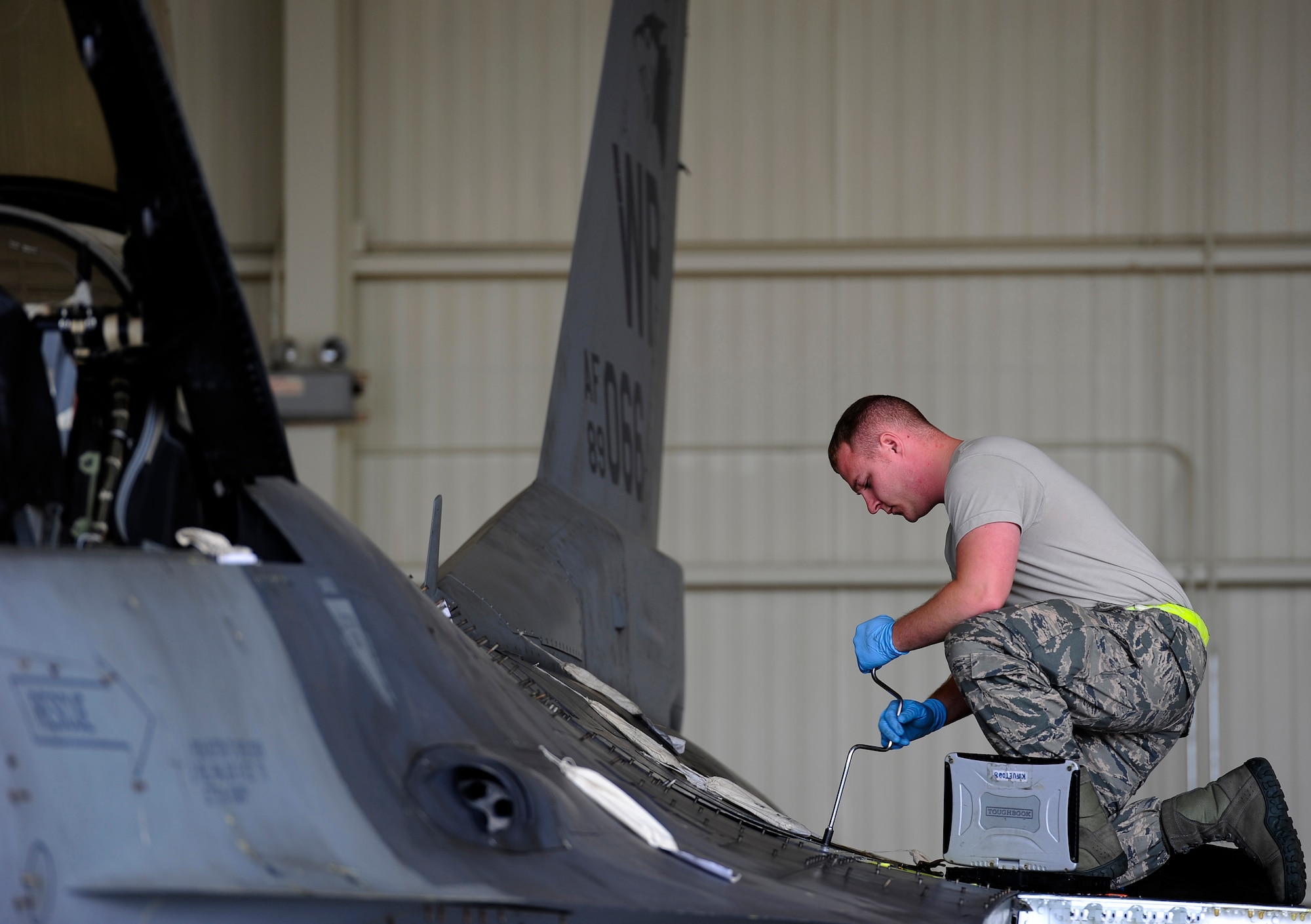 Senior Airman Jacob Clark, 8th Maintenance Squadron aircraft fuels systems journeyman, inspects an F-16 Fighting Falcon at Kunsan Air Base, Republic of Korea, Oct. 29, 2015. The fuels section is responsible for inspecting and repairing aircraft fuel systems, in-flight refueling receptacle systems, and other related components across F-16 aircraft. (U.S. Air Force photo by Staff Sgt. Nick Wilson/Released)