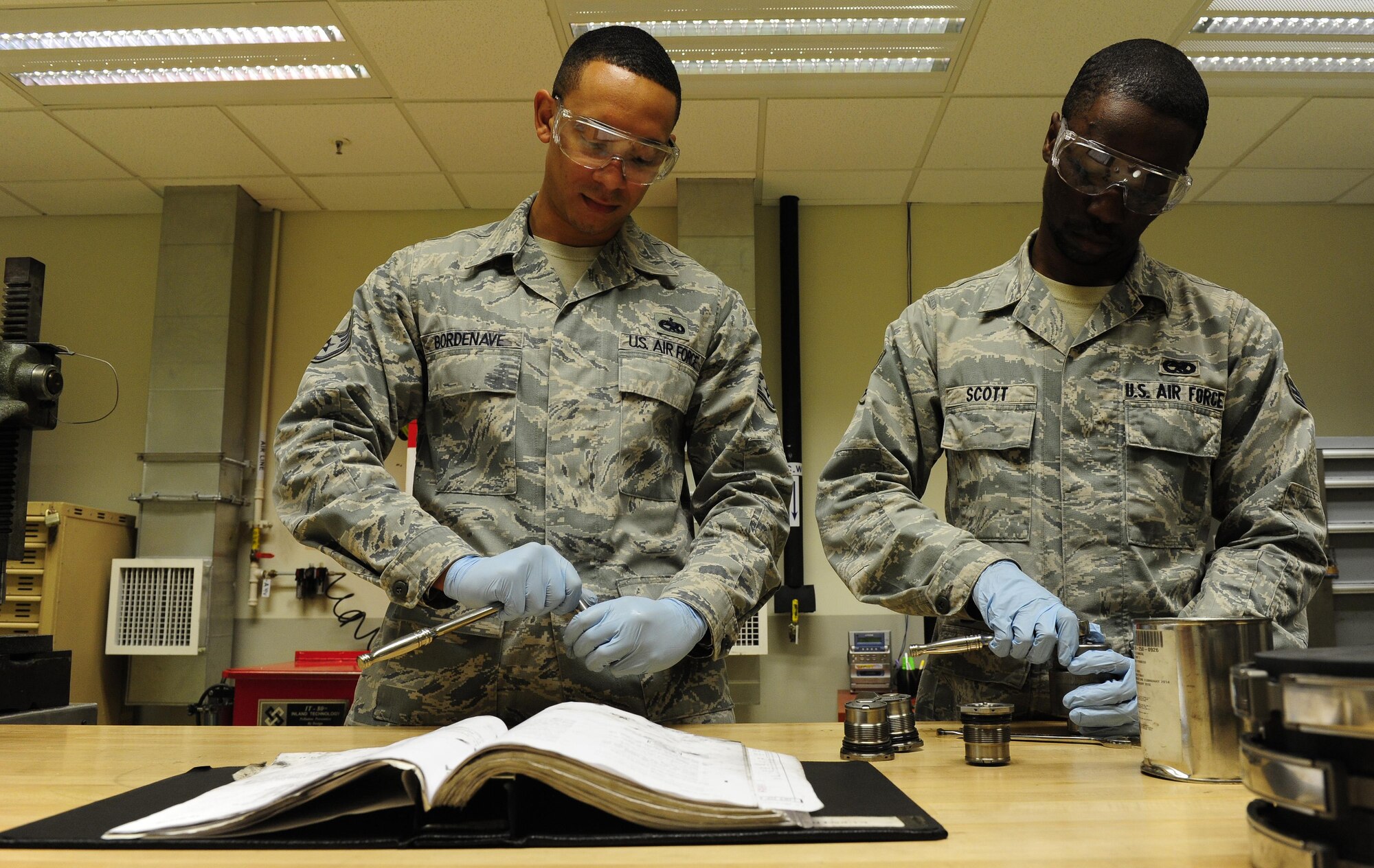 Staff Sgt. Aljhaun Bordenave, 8th Maintenance Squadron hydraulics section chief, and Senior Airman Isaiah Scott, 8th MXS hydraulics journeyman, assemble landing gear brakes at Kunsan Air Base, Republic of Korea, Oct. 29, 2015. The hydraulics section is responsible for supporting the flight line, phase dock and aerospace ground equipment flight by rebuilding hydraulic components. (U.S. Air Force photo by Staff Sgt. Nick Wilson/Released)