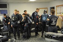 Members of the U.S. Air Force Wings of Blue prepare to step to their aircraft prior to a free fall jump Nov. 1, 2015 at Joint Base San Antonio-Randolph, Texas. Air shows allow the Air Force to display the capabilities of our aircraft to the American taxpayer through aerial demonstrations and static displays and allowing attendees to get up close and personal to see some of the equipment and aircraft used by the U.S. military today. (U.S. Air Force photo by Melissa Peterson) 