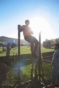 Ray Duffy, a massage therapist student from Oceanside, Calif., challenges himself at the Army Reserve challenge flanked by drill sergeants from 2nd Battalion, 413th Regiment, 95th Training Division at the 2015 Southern California Tough Mudder race in Temecula Oct. 31. The U.S. Army Reserve was a sponsor of the Tough Mudder this year, which meant Reserve Soldiers spotted, motivated and assisted racers at the obstacles. Duffy said he wanted to try the challenge (pushing a weighted sled, five pullups, low crawl, 20 pushups, and pulling the weighted sled back into place), because it looked like fun and he’s a supporter of the U.S. Army. (Photo by Sgt. 1st Class Alexandra Hays, 201st Press Camp Headquarters)