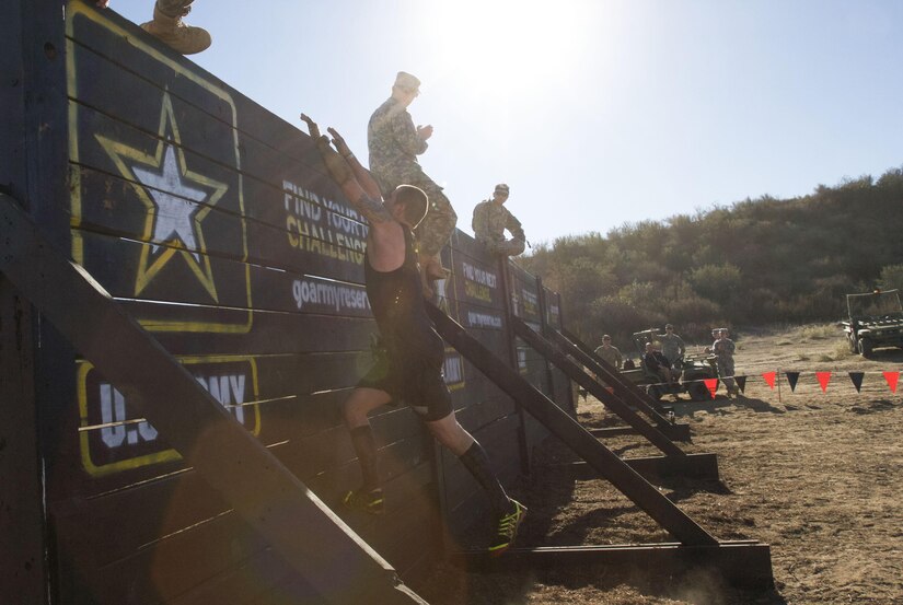 A competitor at the 2015 Southern California Tough Mudder in Temecula, Calif., Oct. 31, 2015, attempts the “Berlin Wall,” one of the 21 obstacles in this year’s event, flanked by Army Reserve Soldiers from the 315th and 305th Engineering Battalions out of Camp Pendleton, Calif. The U.S. Army Reserve was a sponsor of the Tough Mudder this year, which meant Reserve Soldiers spotted, motivated and assisted racers at the obstacles. (Photo by Sgt. 1st Class Alexandra Hays, 201st Press Camp Headquarters)