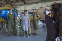 Cristian Piriz from San Antonio, Tx, poses for a photo with Joint Base San Antonio members that are dressed up in authentic World War II uniforms during the 2015 Joint Base San Antonio Air Show and Open House Nov. 1, 2015 at JBSA-Randolph. Air shows allow the Air Force to display the capabilities of our aircraft to the American taxpayer through aerial demonstrations and static displays. JBSA-Randolph’s air show allowed attendees to get up close and personal to see some of the equipment and aircraft used by the U.S. military today. (U.S. Air Force photo by Joshua Rodriguez/Released)