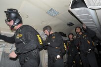 Members of the U.S. Army Golden Knights prepare to jump out of an aircraft during the 2015 Joint Base San Antonio Air Show and Open House Nov. 1, 2015 at JBSA-Randolph. The United States Army Parachute Team, nicknamed and commonly known as the Golden Knights, is a demonstration and competition parachute team of the United States Army.The demonstration teams, which use five dedicated aircraft, perform at more than 100 events per year. (U.S. Air Force photo by Joel Martinez/Released)