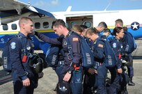 Members of the U.S. Air Force Wings of Blue prepare to step to their aircraft prior to a free fall jump during the 2015 Joint Base San Antonio Air Show and Open House Nov. 1, 2015 at Joint Base San Antonio-Randolph, Texas. Air shows allow the Air Force to display the capabilities of our aircraft to the American taxpayer through aerial demonstrations and static displays and allowing attendees to get up close and personal to see some of the equipment and aircraft used by the U.S. military today. (U.S. Air Force photo by Melissa Peterson) 