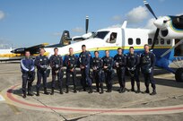Members of the U.S. Air Force Wings of Blue pause for a group photo prior to their performance during the 2015 Joint Base San Antonio Air Show and Open House Nov. 1, 2015 at Joint Base San Antonio-Randolph, Texas. Air shows allow the Air Force to display the capabilities of our aircraft to the American taxpayer through aerial demonstrations and static displays and allowing attendees to get up close and personal to see some of the equipment and aircraft used by the U.S. military today. (U.S. Air Force photo by Melissa Peterson) 