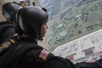 Sgt. First Class Jennifer Espinosa, U.S. Army Parachute Team “Golden Knights” demonstration parachutist, looks out at the Joint Base San Antonio Air Show and Open House Nov. 1, 2015, at JBSA-Randolph. Air shows allow the Air Force and sister services to display the capabilities of military aircraft and members to the American taxpayer through aerial demonstrations and static displays.