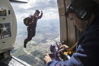 Manny Garcia, 25th Air Force videographer, films Staff Sgt. Mike Koch, U.S. Army Parachute Team “Golden Knights” as he jumps out of the Army Golden Knight’s aircraft during the Joint Base San Antonio Air Show and Open House Nov. 1, 2015, at JBSA-Randolph. The Golden Knights have a threefold mission: recruit the next generation of Soldiers, support public outreach through conducting tandem parachute jumps and compete against the world’s best skydivers at national and international parachuting competitions.