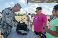 Senior Airman Cody Rodgers from the 502nd Logistics Readiness Squadron searches bags of visitors during the 2015 Joint Base San Antonio Air Show and Open House Nov. 1, 2015 at JBSA-Randolph, Texas. Air shows allow the Air Force to display the capabilities of our aircraft to the American taxpayer through aerial demonstrations and static displays. JBSA-Randolph’s air show allowed attendees to get up close and personal to see some of the equipment and aircraft used by the U.S. military today. (U.S. Air Force photo by Joshua Rodriguez/Released)