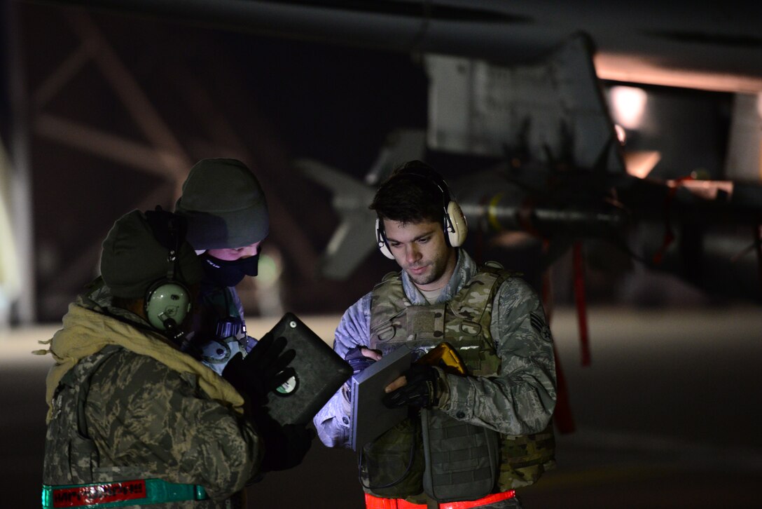 Senior Airmen Jonathon Simmons, 25th Aircraft Maintenance Unit load master, reviews system operational guidelineswith his crew during the first night of Vigilant Ace 16 at Osan Air Base, Republic of Korea, Nov. 2, 2015. Vigilant Ace 16 is a peninsula-wide readiness exercise geared toward strengthing the interoperability of the ROK/U.S.  alliance. (U.S. Air Force photo/Staff Sgt. Amber Grimm)