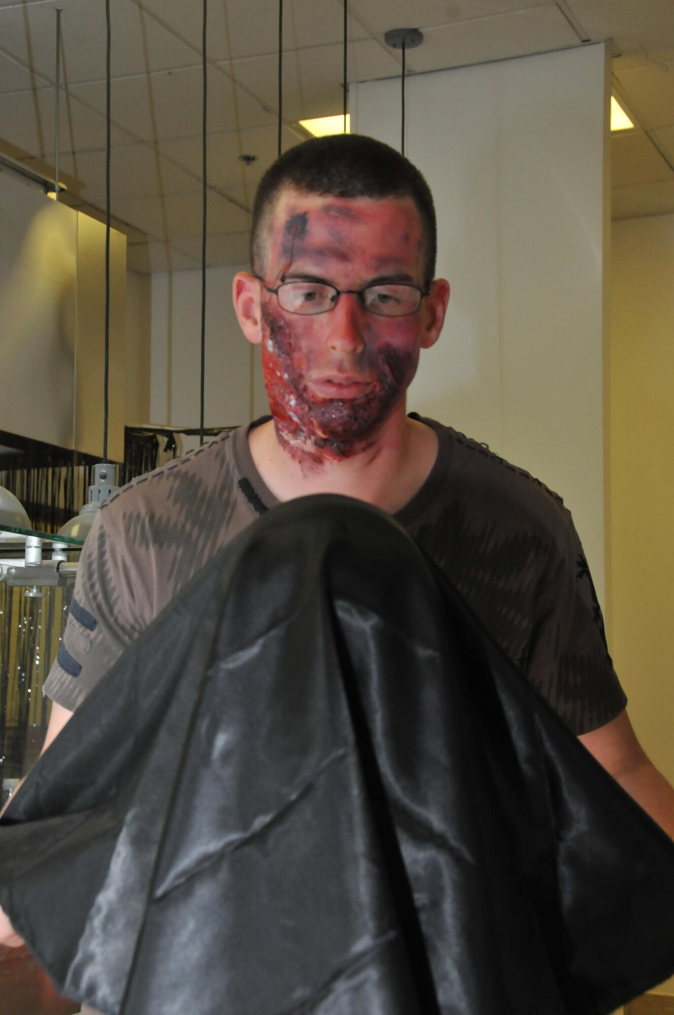 Senior Airman Jerry Harrison, the 379th Expeditionary Force Support Squadron rations clerk, participates in the haunted house as a zombie magician Oct. 30 at Al Udeid Air Base, Qatar. Harrison has been practicing magic for over 10 years. He said Halloween is his favorite time of the year. (U.S. Air Force photo by Tech. Sgt. Terrica Y. Jones/Released)