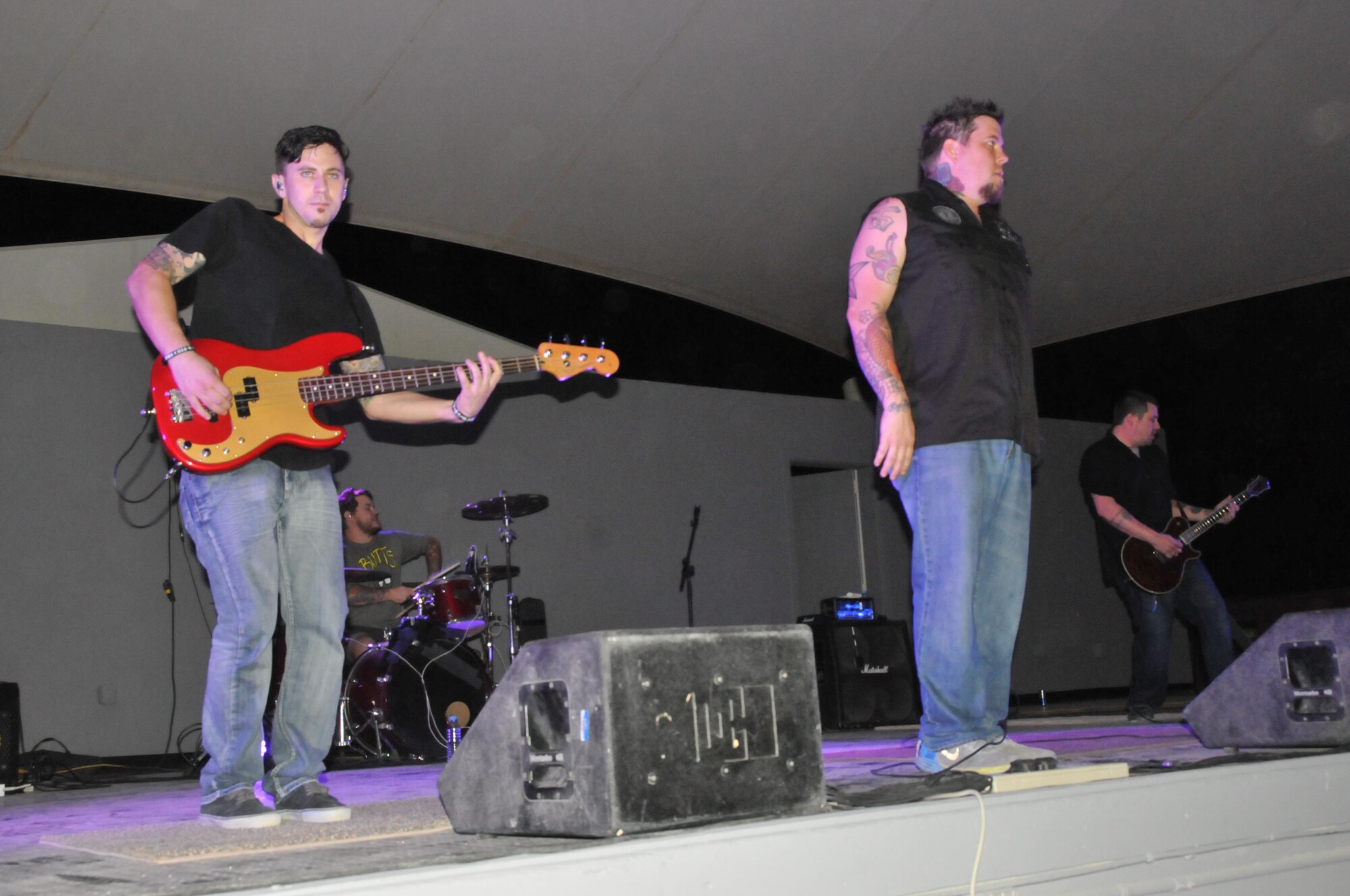 12 Stones plays for service members at Al Udeid Air Base, Qatar Oct. 30. The 379th Expeditionary Force Support Squadron sponsored the band’s performance here. During the show Paul McCoy, the bands’ lead singer, jumps on a table encouraging the crowd of listeners to clap and make some noise. (U.S. Air Force photo by Tech. Sgt. Terrica Y. Jones/Released)

