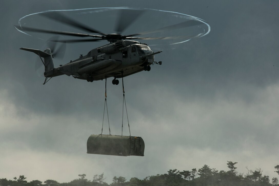 A CH-53E Super Stallion helicopter inserts components of the Improved Ribbon Bridge into the water in the Central Training Area, Okinawa, Japan, during Blue Chromite 2016, Nov. 2, 2015. This was the first time that Improved Ribbon Bridges, flat modular-floating platforms that bridge wet gaps, were inserted by air on Okinawa. Blue Chromite is a large-scale amphibious exercise that draws primarily from III Marine Expeditionary Force’s training resources on Okinawa. The location of the training allows participating units to maintain a forward-deployed posture and eliminates the cost of traveling to train. The Super Stallion is with Marine Heavy Helicopter Squadron 462. (U.S. Marine Corps photo by Cpl. Drew Tech/Released)