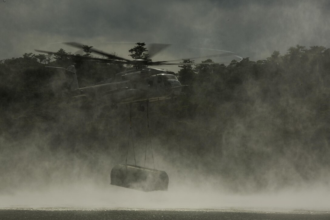 A CH-53E Super Stallion helicopter inserts components of the Improved Ribbon Bridge into the water in the Central Training Area, Okinawa, Japan, during Blue Chromite 2016, Nov. 2, 2015. This was the first time that Improved Ribbon Bridges, flat modular-floating platforms that bridge wet gaps, were inserted by air on Okinawa. Blue Chromite is a large-scale amphibious exercise that draws primarily from III Marine Expeditionary Force’s training resources on Okinawa. The location of the training allows participating units to maintain a forward-deployed posture and eliminates the cost of traveling to train. The Super Stallion is with Marine Heavy Helicopter Squadron 462. (U.S. Marine Corps photo by Cpl. Drew Tech/Released)