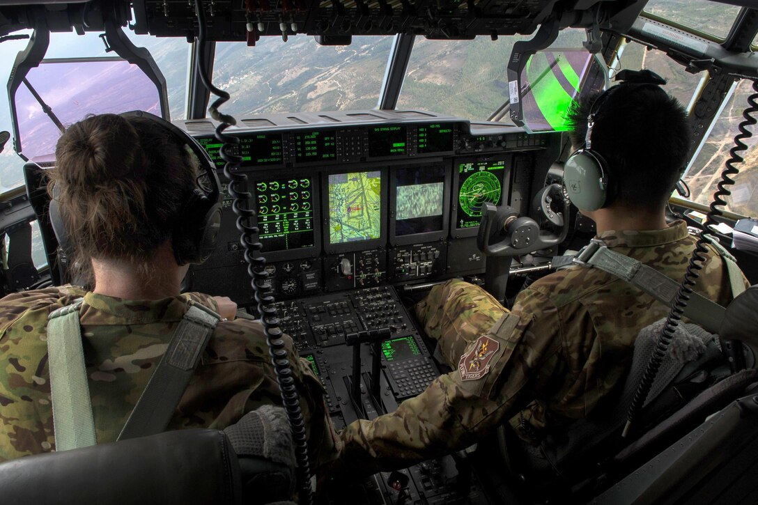Two pilots fly a C-130J Hercules aircraft during Trident Juncture near Beja Air Base, Portugal, Oct. 23, 2015. The pilots are assigned to the 71st Rescue Squadron. U.S. Air Force photo by Airman 1st Class Luke Kitterman