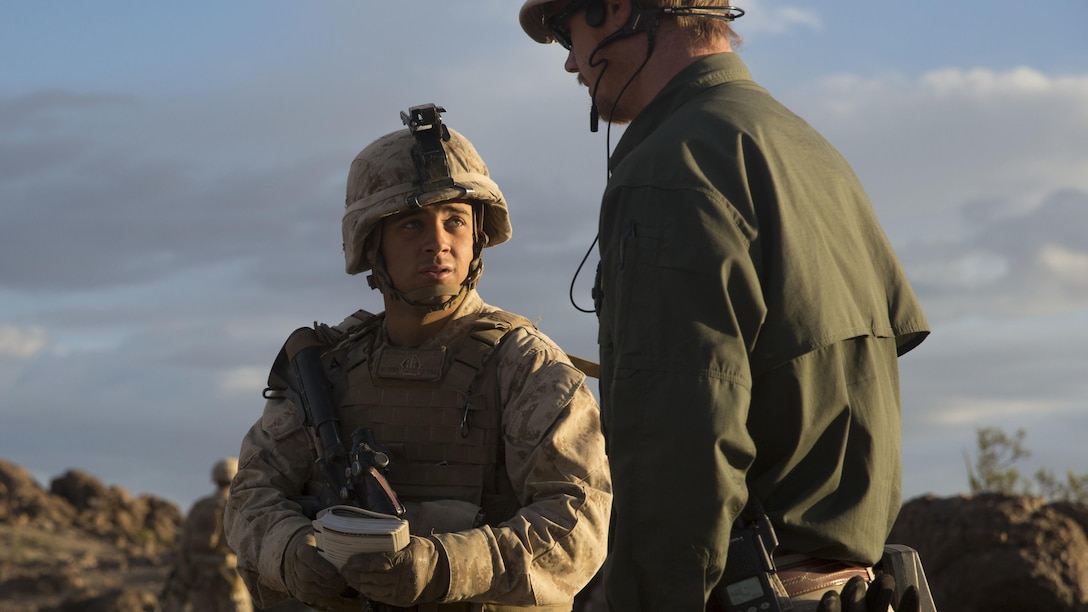 Lance Corporal John Roan, left, a squad leader with E Company, 2nd Battalion, 2nd Marine Regiment positively identified an improvised explosive device just before speaking with one of the instructors during Integrated Training Exercise 1-16 at Marine Air Ground Combat Center, Twentynine Palms, Calif., Oct. 29, 2015. Marines at ITX demonstrate core infantry mission essential tasks while conducting offensive and defensive operations.
