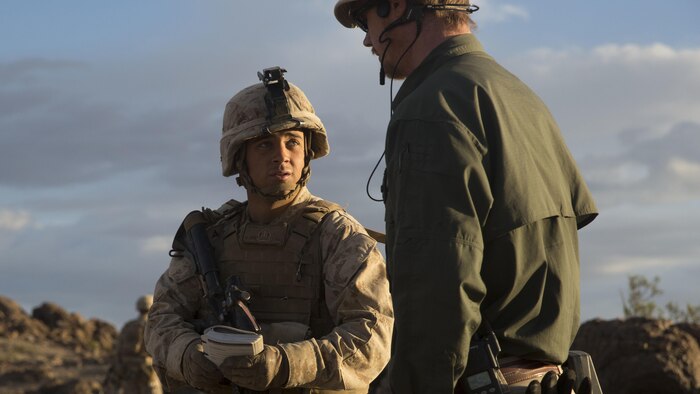 Lance Corporal John Roan, left, a squad leader with E Company, 2nd Battalion, 2nd Marine Regiment positively identified an improvised explosive device just before speaking with one of the instructors during Integrated Training Exercise 1-16 at Marine Air Ground Combat Center, Twentynine Palms, Calif., Oct. 29, 2015. Marines at ITX demonstrate core infantry mission essential tasks while conducting offensive and defensive operations.