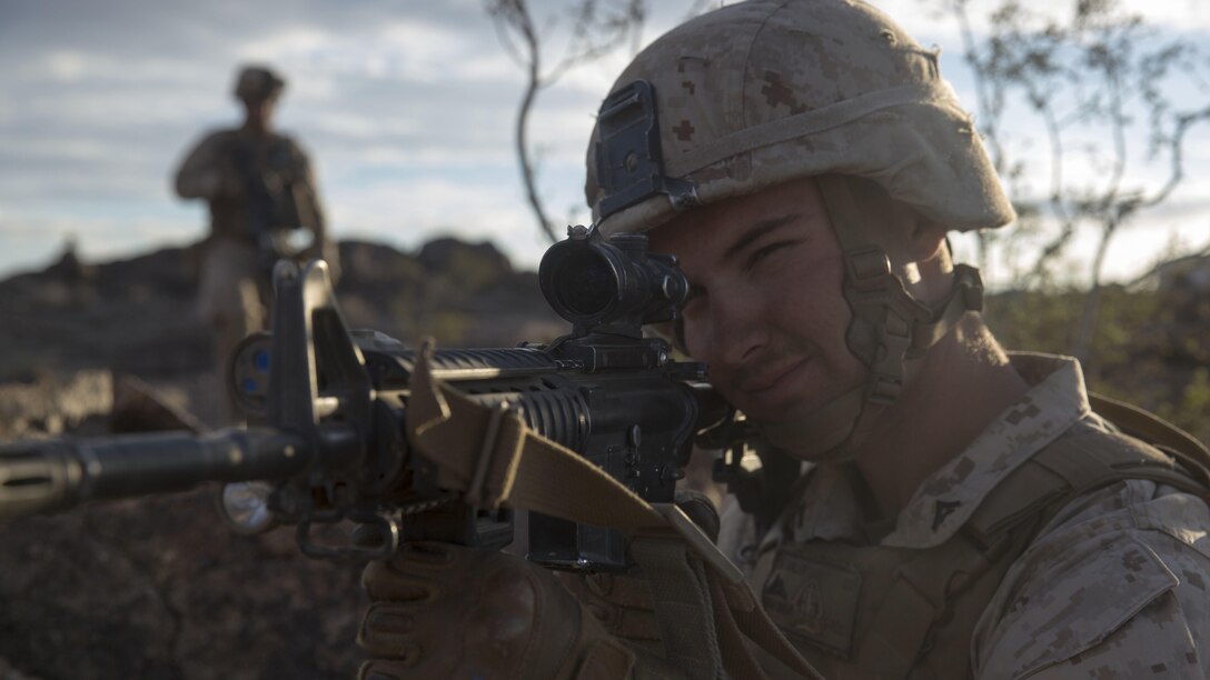 Lance Corporal Tyler Miller, a rifleman with E Company, 2nd Battalion, 2nd Marine Regiment posts security during Integrated Training Exercise 1-16 at Marine Air Ground Combat Center, Twentynine Palms, Calif., Oct. 29, 2015. Marines at ITX demonstrate core infantry mission essential tasks while conducting offensive and defensive operations.