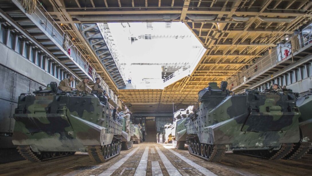 Amphibious assault vehicles wait in the well deck of the amphibious dock landing ship USS Germantown (LSD 42) before launching to head ashore for a personnel swap during exercise Blue Chromite 16 in Okinawa, Japan, Oct. 27, 2015. BC 16 is a U.S. only exercise designed to increase amphibious proficiency between the Navy and Marine Corps. 