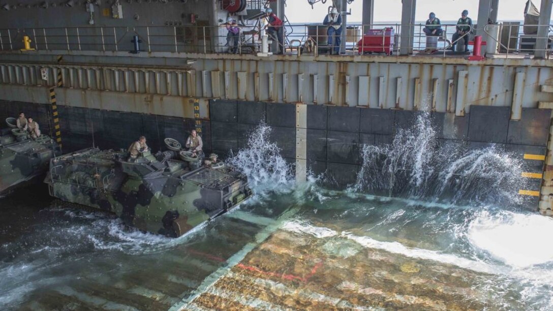 Amphibious assault vehicles wait in the well deck of the amphibious dock landing ship USS Germantown (LSD 42) before launching to head ashore for a personnel swap during exercise Blue Chromite 16, Oct. 27, 2015 off the coast of Okinawa, Japan. BC 16 is a U.S. only exercise designed to increase amphibious proficiency between the Navy and Marine Corps. 