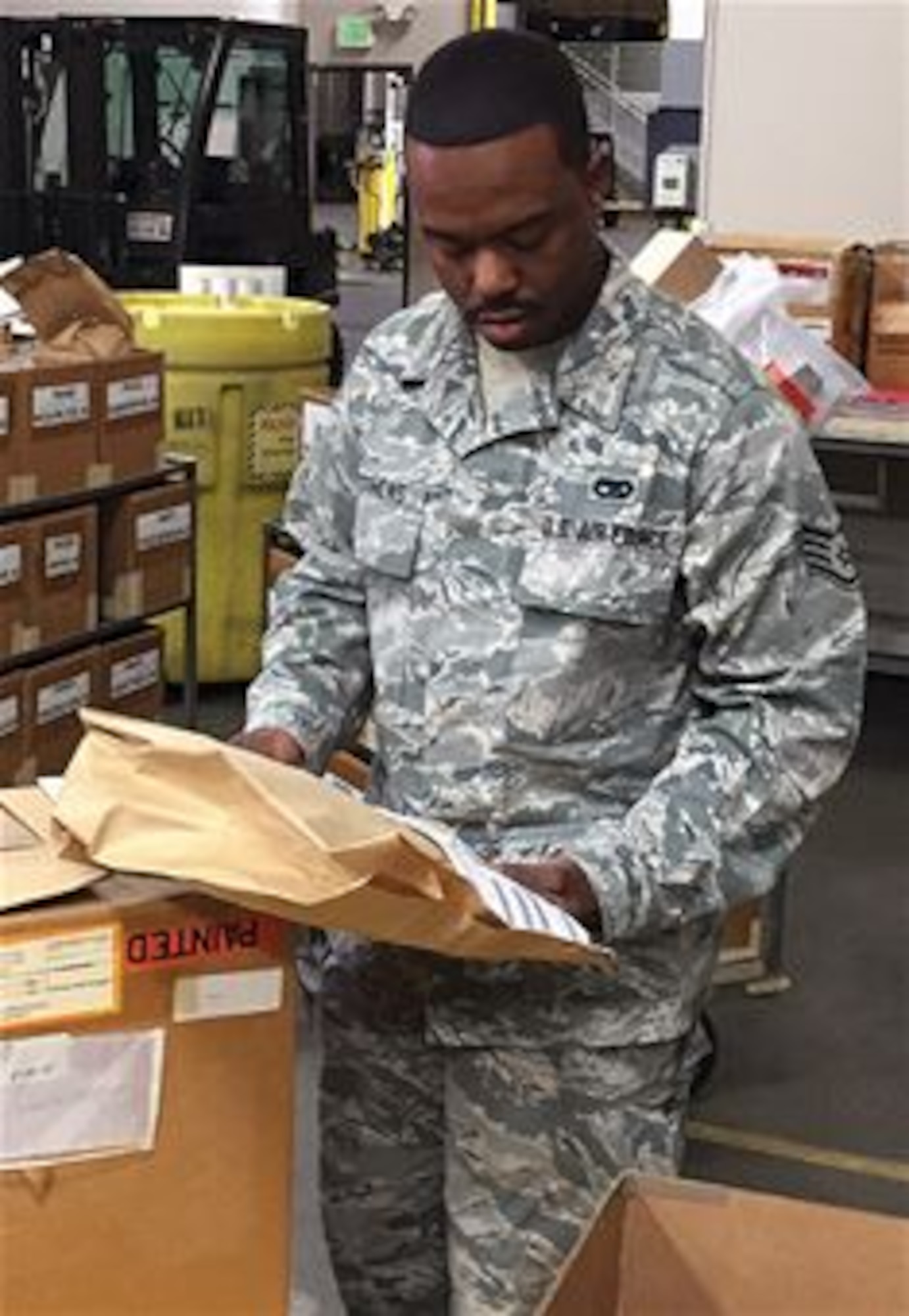 Staff Sgt. Derecus Matthews reviews received household goods information. (U.S. Air Force photo/ Courtesy)
