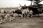 Texas National Guard Soldiers with 3rd Battalion, 141st Infantry Regiment, board a UH-1J helicopter, a variant of the UH-1J Iroquois, provided by the Japan Ground Self-Defense Force Eastern Army, 1st Division, 1st Aviation, at the heliborne tactical training exercise during Orient Shield 2011 at Kita-Fuji Training Area, Japan Oct. 13, 2011.